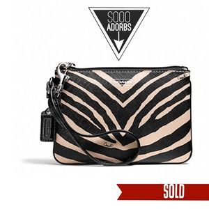 SOLD. Coach zebra print Wristlet