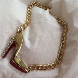 Chunky gold and red stiletto heel necklace.