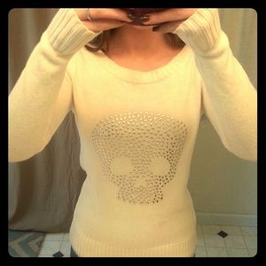 Fashion sweater with silver jeweled skull detail.