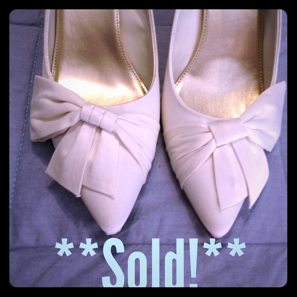 **Sold!** Ivory Bow Pumps