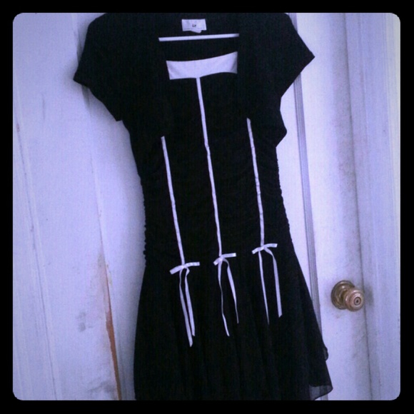 A black dress with white ribbons on the front - Picture 1 of 4