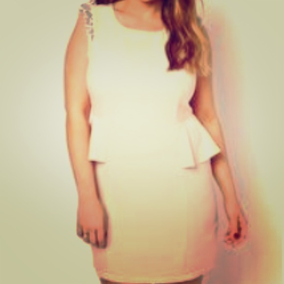 Never worn. Nude peplum embellished shoulders.