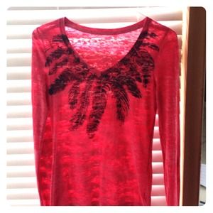 Red long sleeved T-shirt with rhinestones.