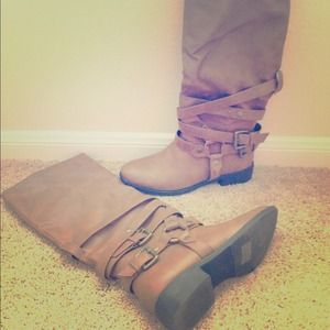 Hold Charming Charlie's brown boots