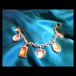 REDUCED!Silver charm bracelet that holds pictures.