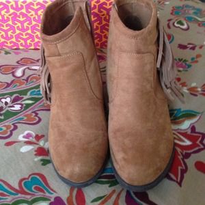 Tan fringe booties.