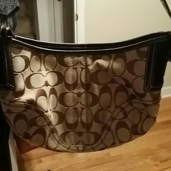 A dark brown and kaki coach purse