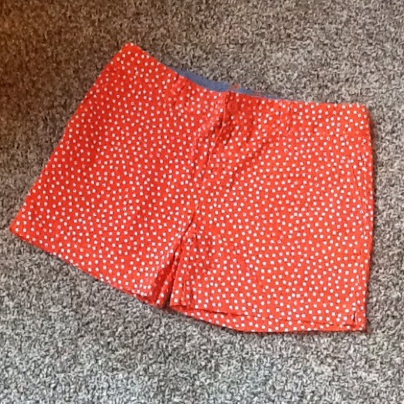 Orange shorts with white polka dots..