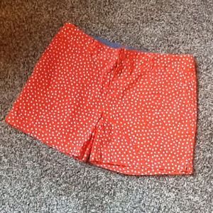 Orange shorts with white polka dots..