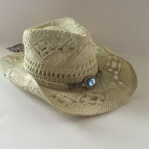 Cowboy hat with light blur jewelry.