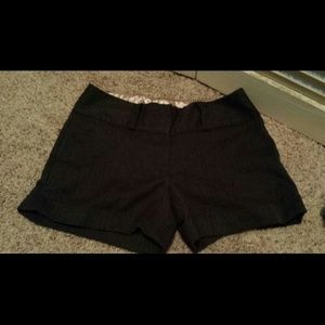 ** Gray, lightly pinstriped shorts.