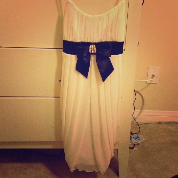 White dress with rhinestones and black bow ribbon