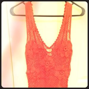 **Holding item** Orange Free People crotchet top