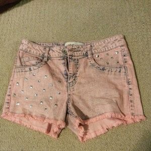 Peach colored high waisted studded shorts
