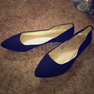 black pointed toe flats.