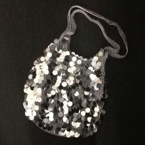 Handbag covered with large silver bangles