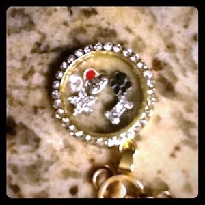 Gold toned floating locket with charms