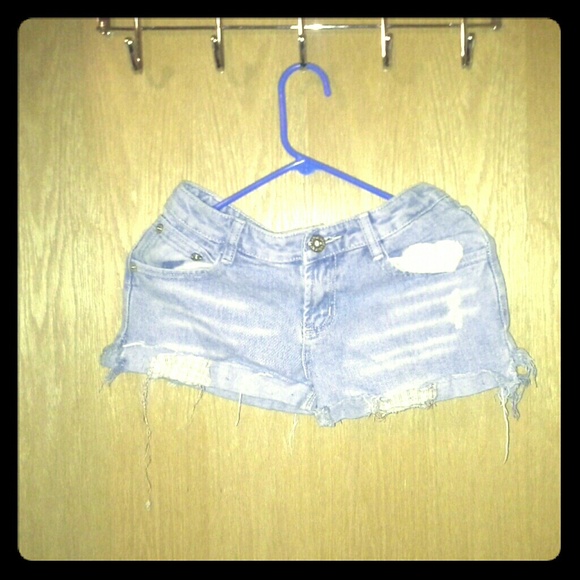 Worn and torn denim shorts