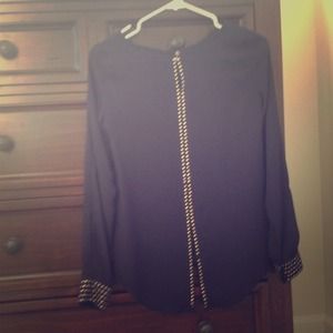 Navy top with metal studs and slit in lower back.