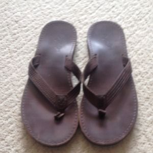 Brown leather flip flops