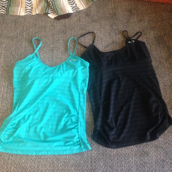 Two Oakley workout tops with shelf bra top