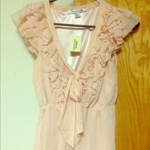 Light pink ruffle top.