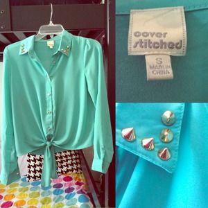 Sheer teal blouse with spikes on the collar.