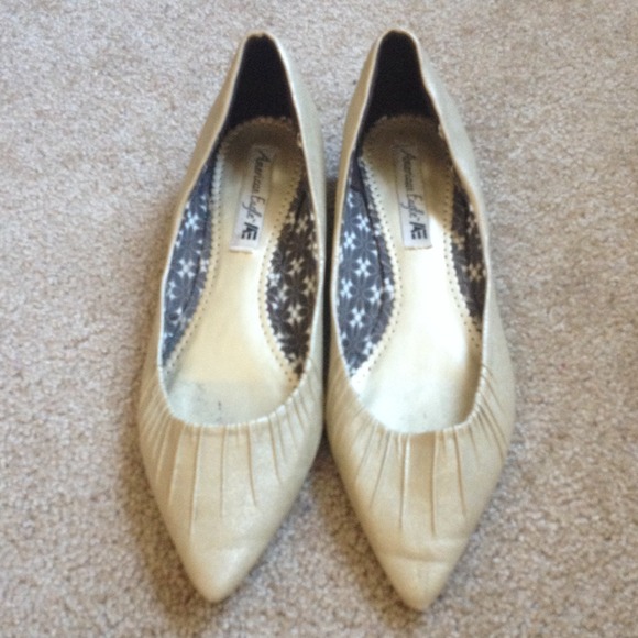American Eagle gold flats with a kitten heel.