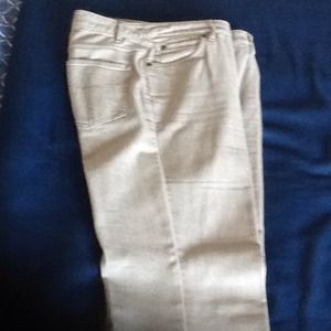 Silver gray stretch denim cut below waist.