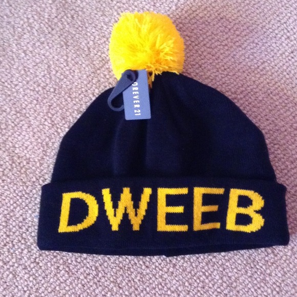Black beanie with Pom at top that says "DWEEB"