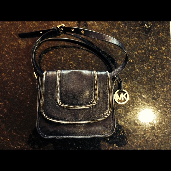 Black cross over bag with gold zippers