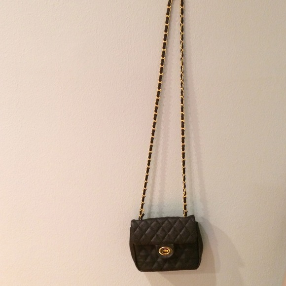 Black quilted bag with gold chain and back pocket