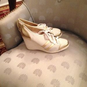 Michael Kors White and Gold wedge sneakers.