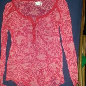 Red see thru long sleeves with swirly designs onbt