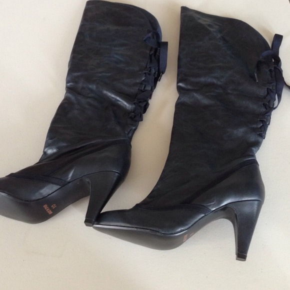 Steve Madden boots laced up in the back. black