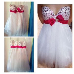 A white bedazzled dress with a pink bow, worn once