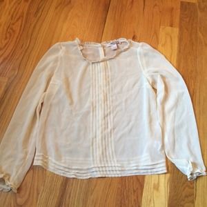 Cream-colored sheer ruffled blouse.