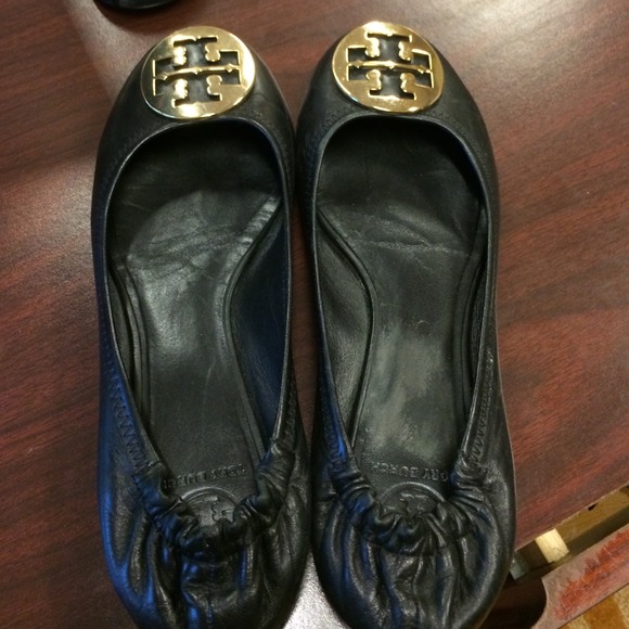 Reva flats with gold emblem