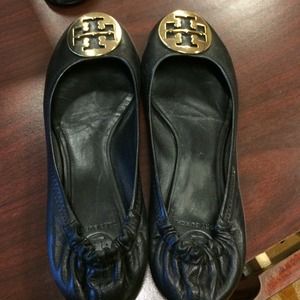 Reva flats with gold emblem