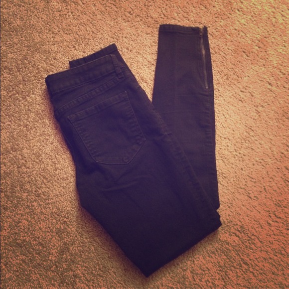 Black denim leggings with gold zippers at ankles
