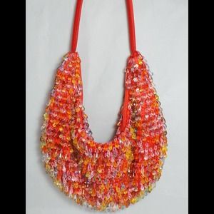 Orange bohemian shoulder bag with plastic beads.