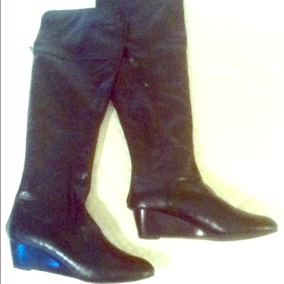 Knee high, black leather boots.