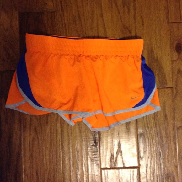 Bright orange/blue nike running shorts.