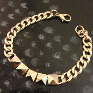 Gold colored link bracelet with studs