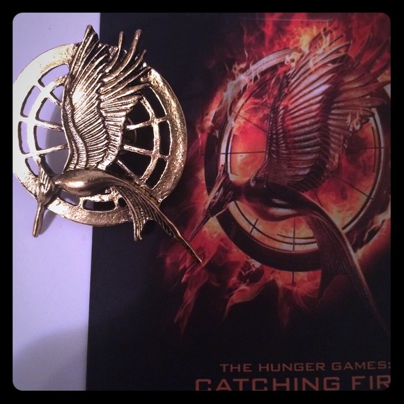 Jewelry - 💙Rare Catching Fire 'Arena' Pin. Tick Tock