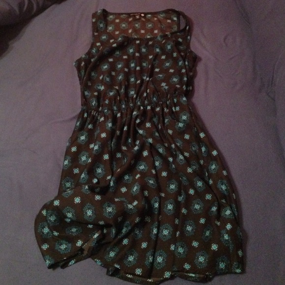 Black dress with blue medallions on it