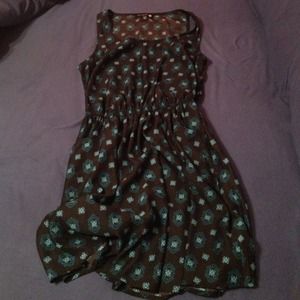 Black dress with blue medallions on it