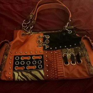 Orange pocketbook with designs.