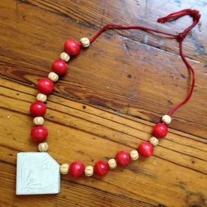 Wooden bead necklace with ceramic pendant