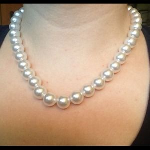 Pearl necklace and matching clip earrings.